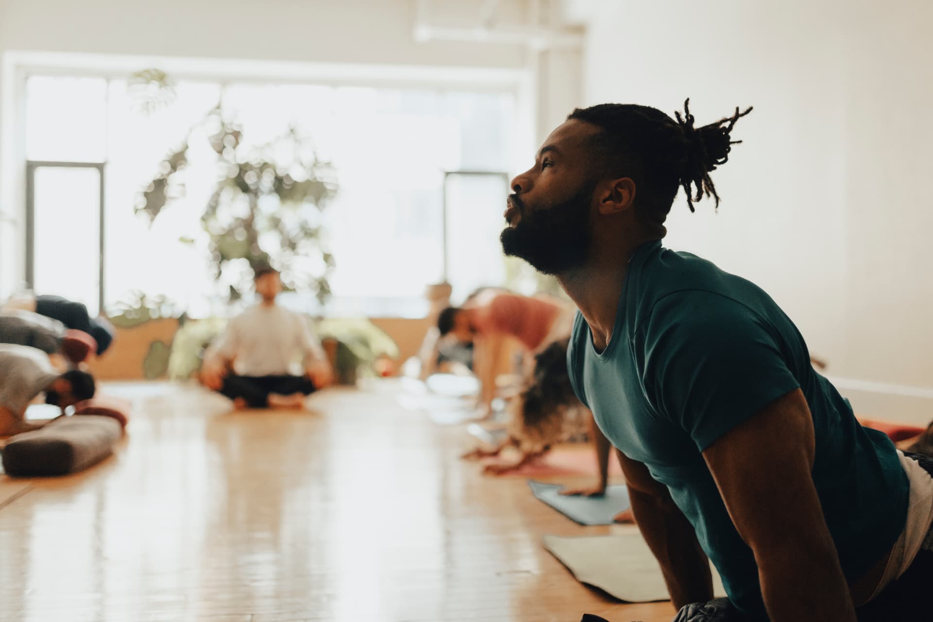 A participant lifting into an open-chest breath during a session